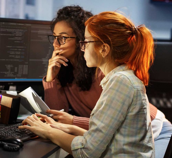 Two woman reviewing data on a computer display