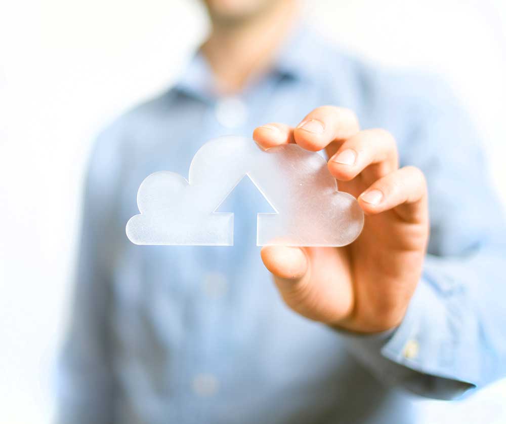 Photo of a man holding a cloud computing icon