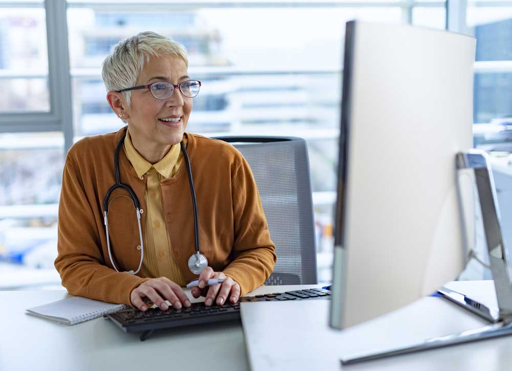 Medical professional uses her computer that is supported by On Line Support's IT Services