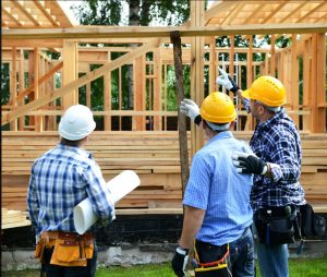 On the job site construction company discussing cost of changing a plan